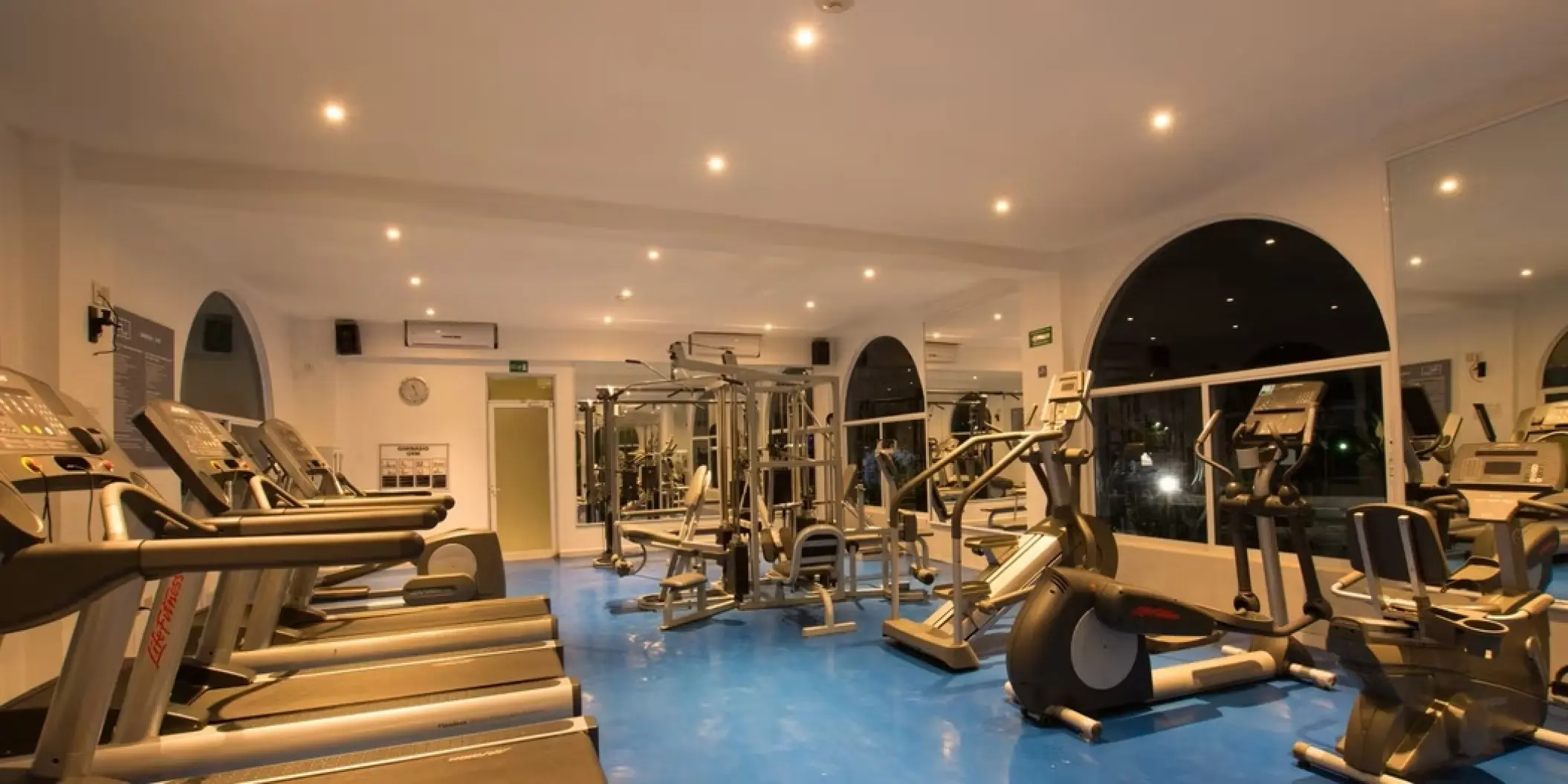 Fitness center with treadmills and weight machines at Occidental Costa Cancun