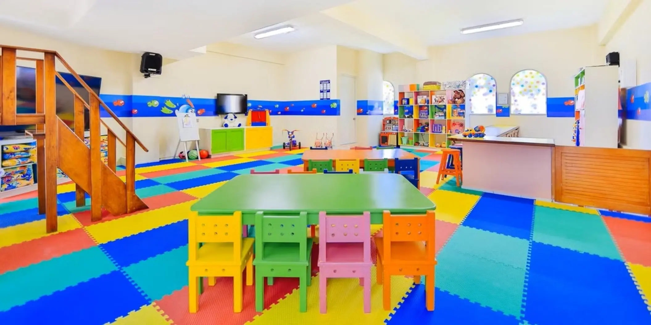 Colorful kids activities center with play mats and small tables at Occidental Costa Cancun