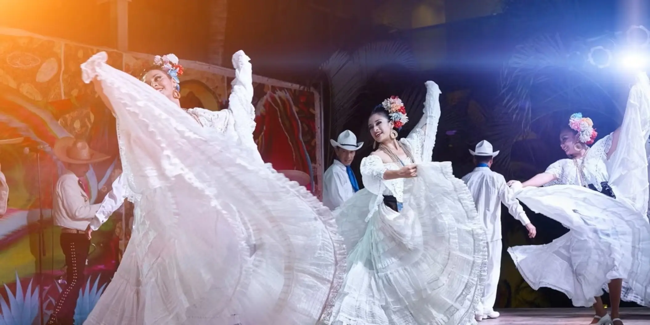 Dancers in white traditional dresses performing at Occidental Costa Cancun