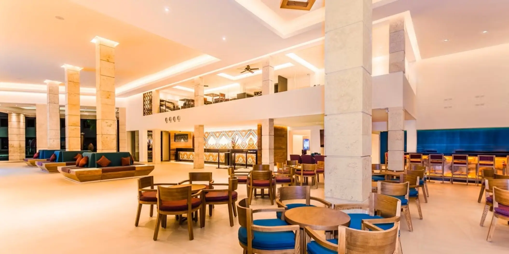 Occidental Costa Cancun lobby with seating areas and stone pillars, Cancun