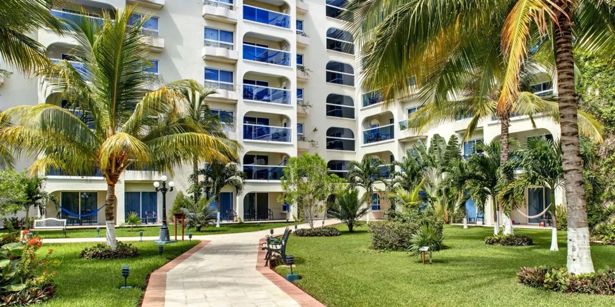 Landscaped gardens and stone pathway through the resort grounds at Occidental Costa Cancun