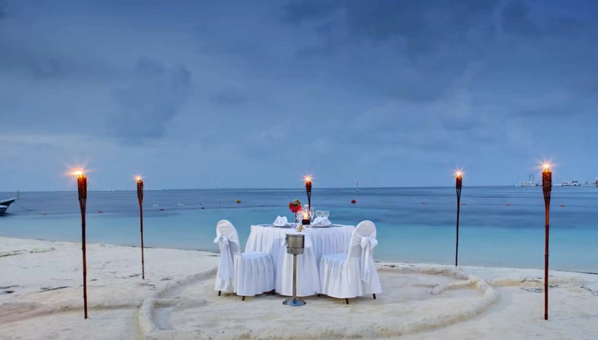 romantic dinner setup on the beach at Occidental Costa Cancun