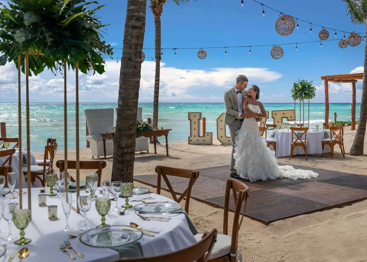 The bride and groom dancing on a beach reception floor at Ocean Allure, Cancun