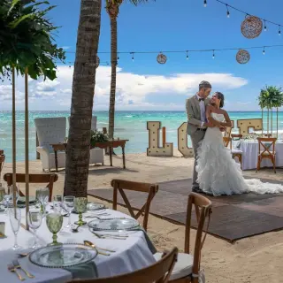 Bride and groom dancing at a beachfront wedding reception at Ocean Allure Costa Mujeres, Cancun