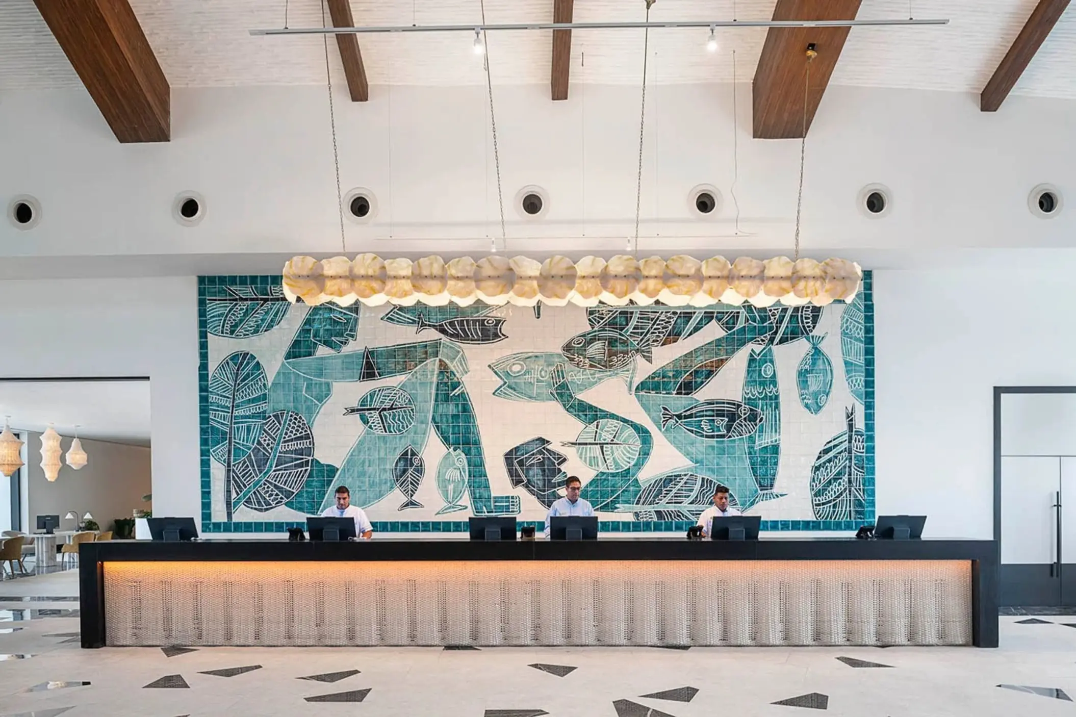 Reception desk with teal mosaic mural at Ocean Allure Costa Mujeres, Cancun