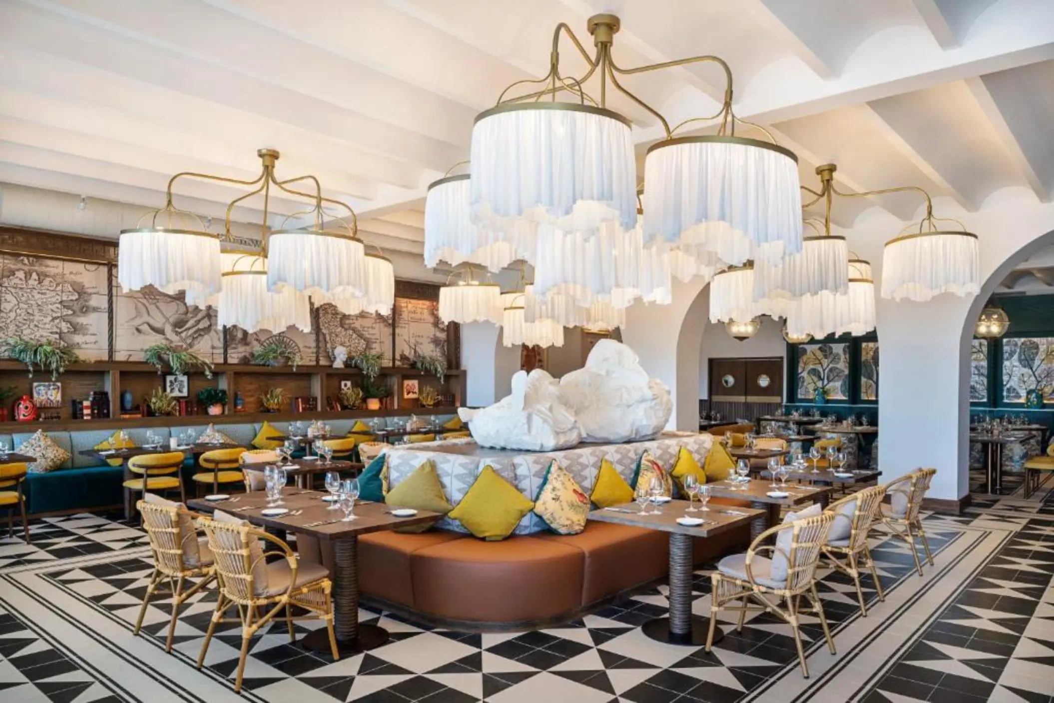 Italian restaurant with white fringed chandeliers and geometric tile floors at Ocean Allure Costa Mujeres, Cancun