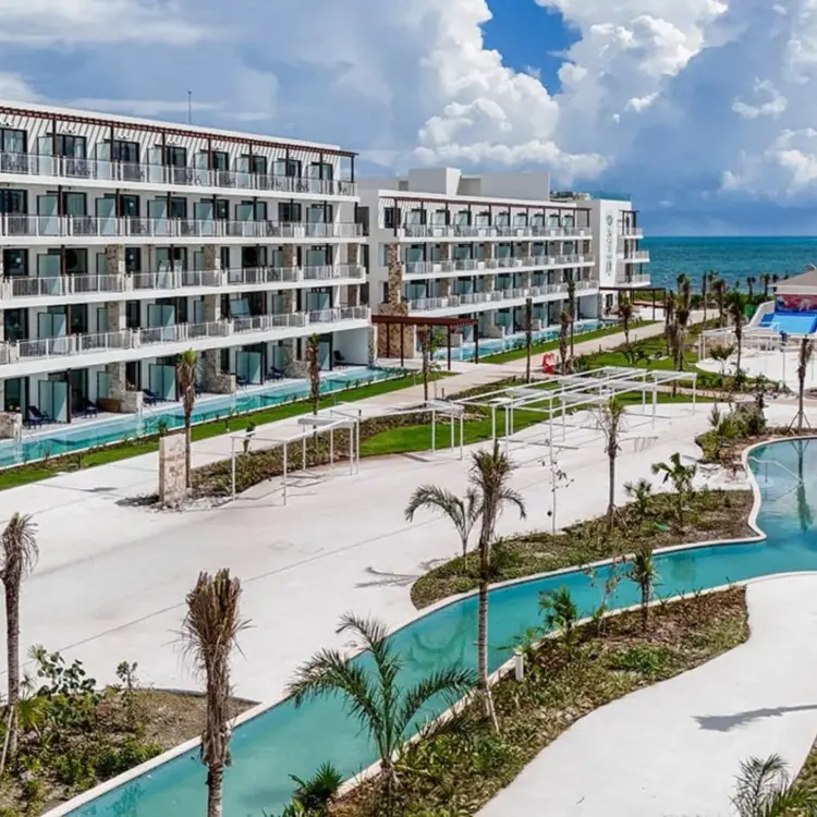 Modern guest room buildings and lazy river at Ocean Allure Costa Mujeres, Cancun