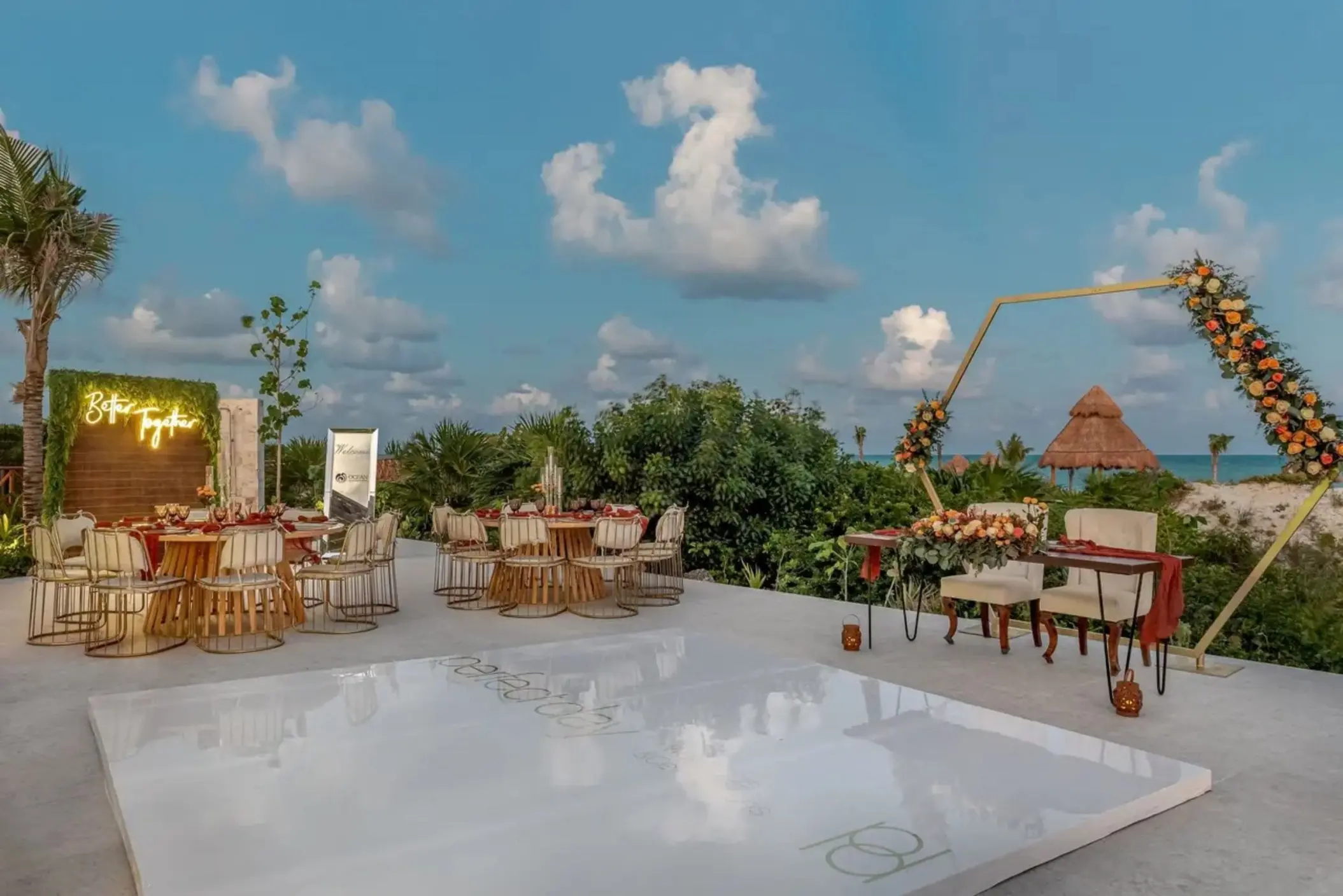 Outdoor wedding reception at Ocean Allure Costa Mujeres with dance floor and floral hexagon arch, Cancun