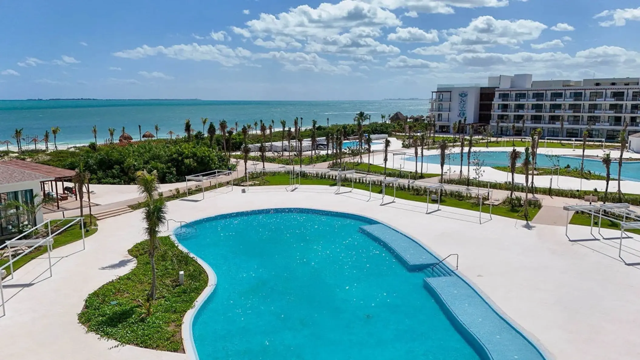 Ocean Allure Costa Mujeres outdoor pools and resort grounds overlooking the turquoise ocean, Cancun