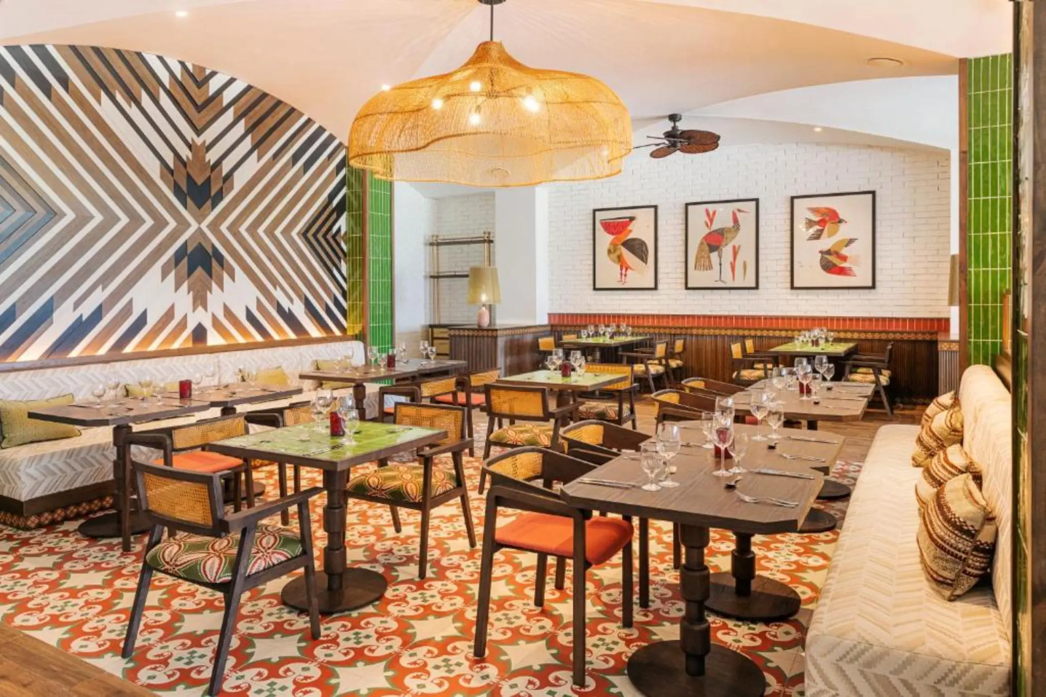 Modern restaurant dining room with patterned floors and geometric wall art at Ocean Allure Costa Mujeres, Cancun