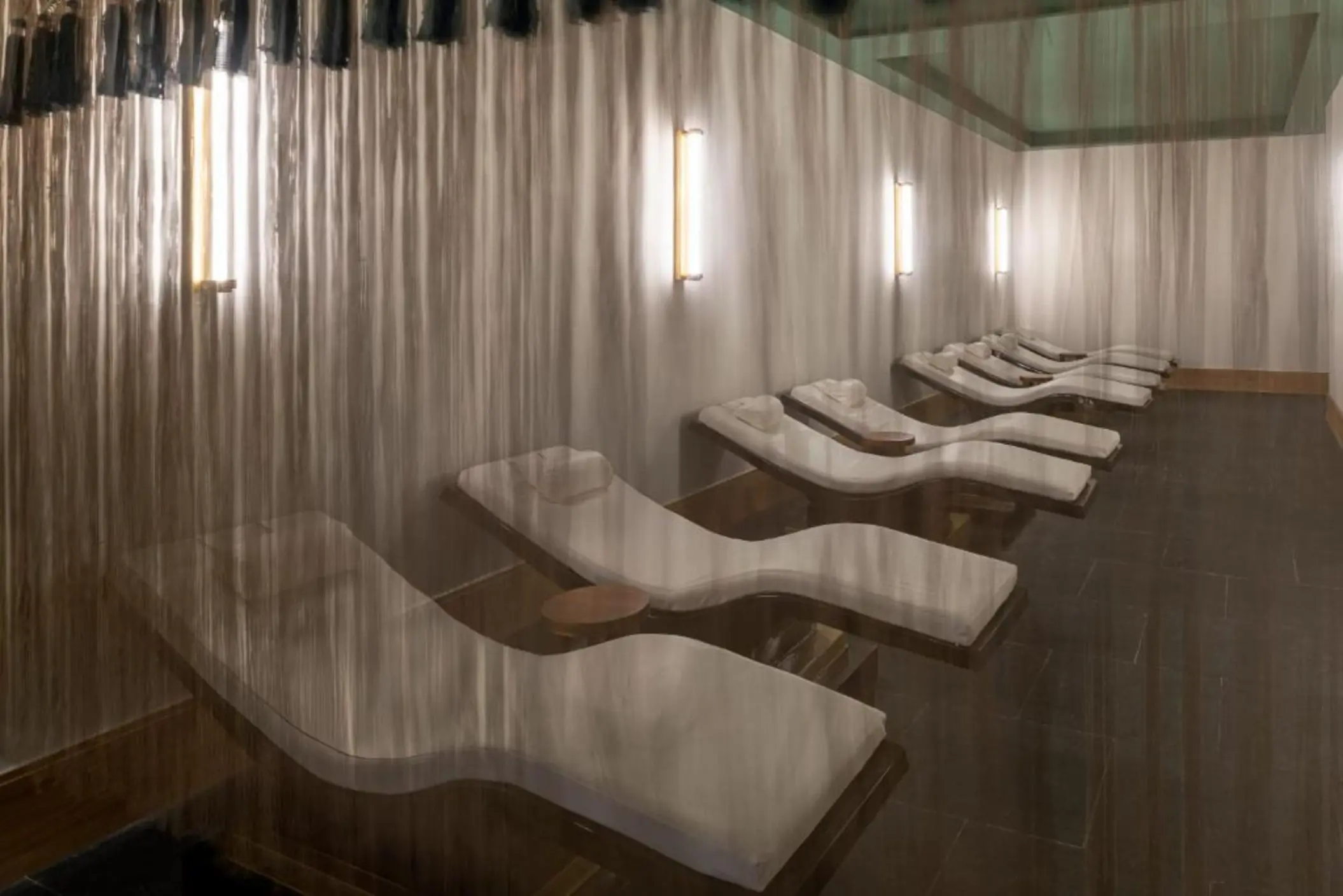 Spa relaxation room with heated loungers and soft lighting at Ocean Allure Costa Mujeres, Cancun