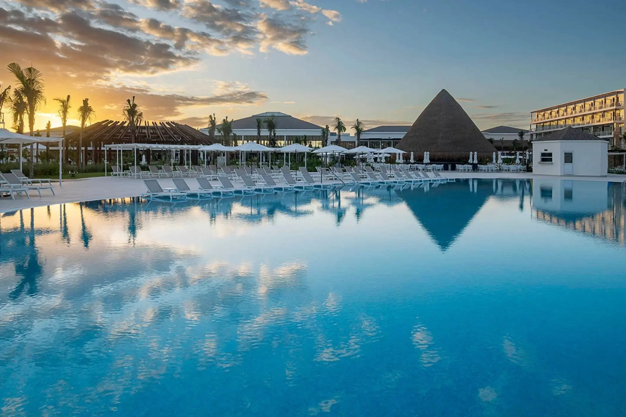 Sunset over the main pool and loungers at Ocean Allure, Cancun