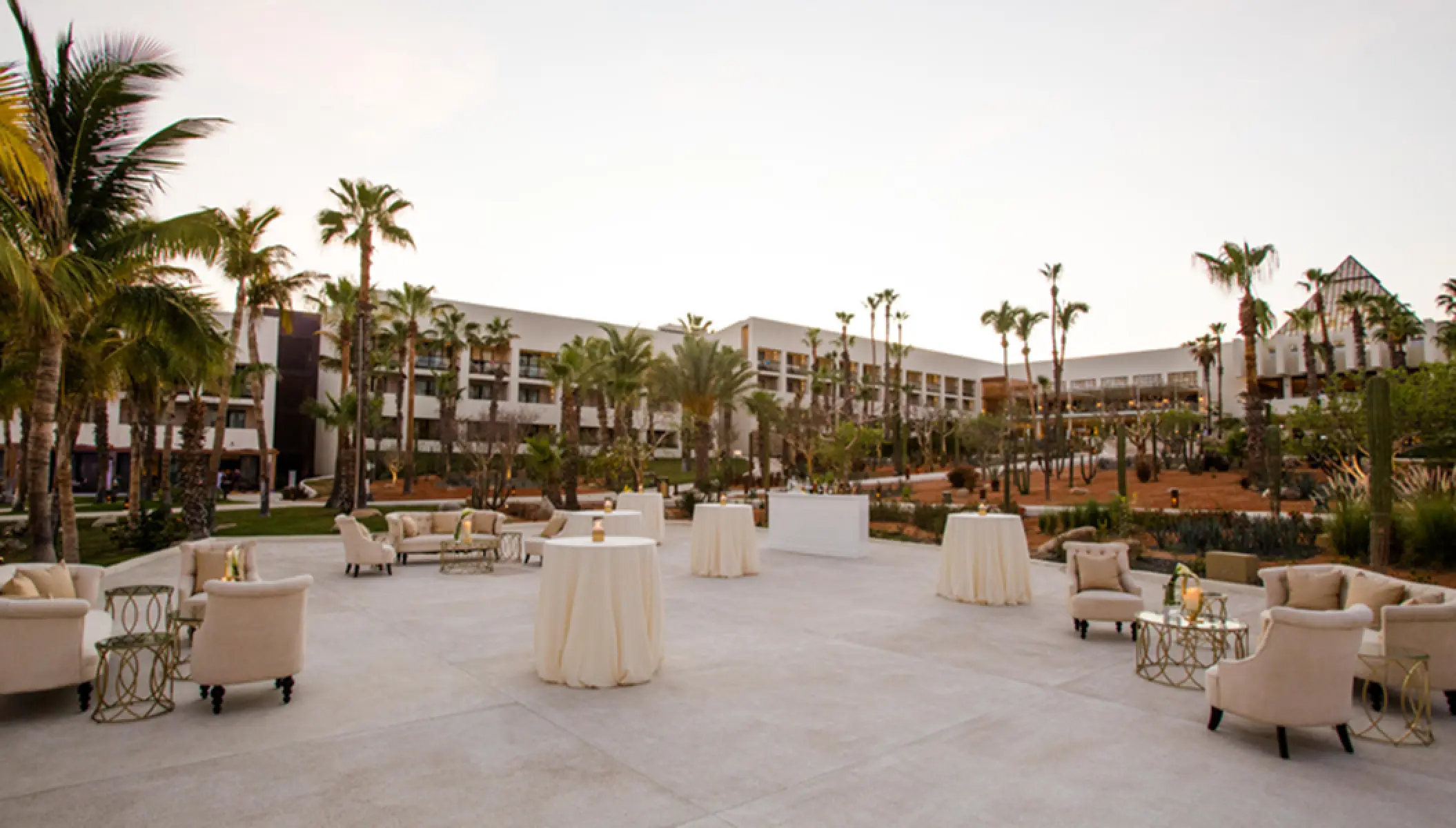 Outdoor cocktail reception setup with white lounge furniture at Paradisus Los Cabos, Cabo San Lucas
