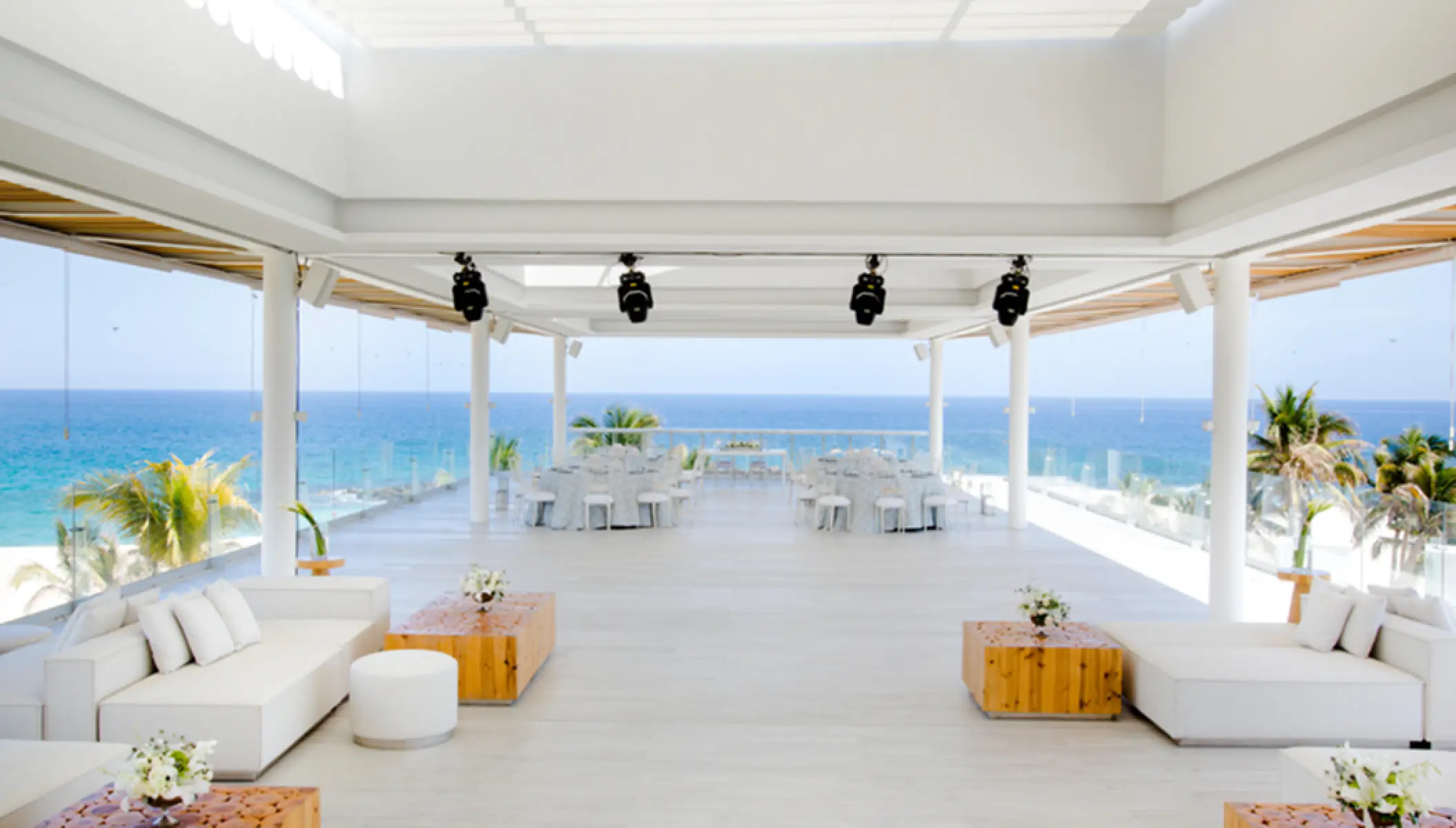 Gaby Sky Bar reception venue with white lounge seating overlooking the ocean at Paradisus Los Cabos, Cabo San Lucas
