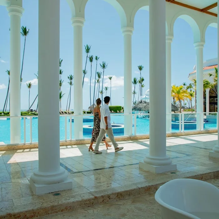 couple waling by the pool at Paradisus Palma Real