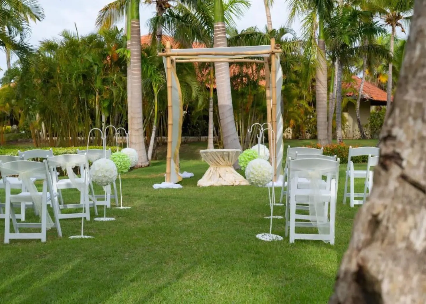 Garden wedding ceremony setup with bamboo huppah at Paradisus Palma Real, Punta Cana