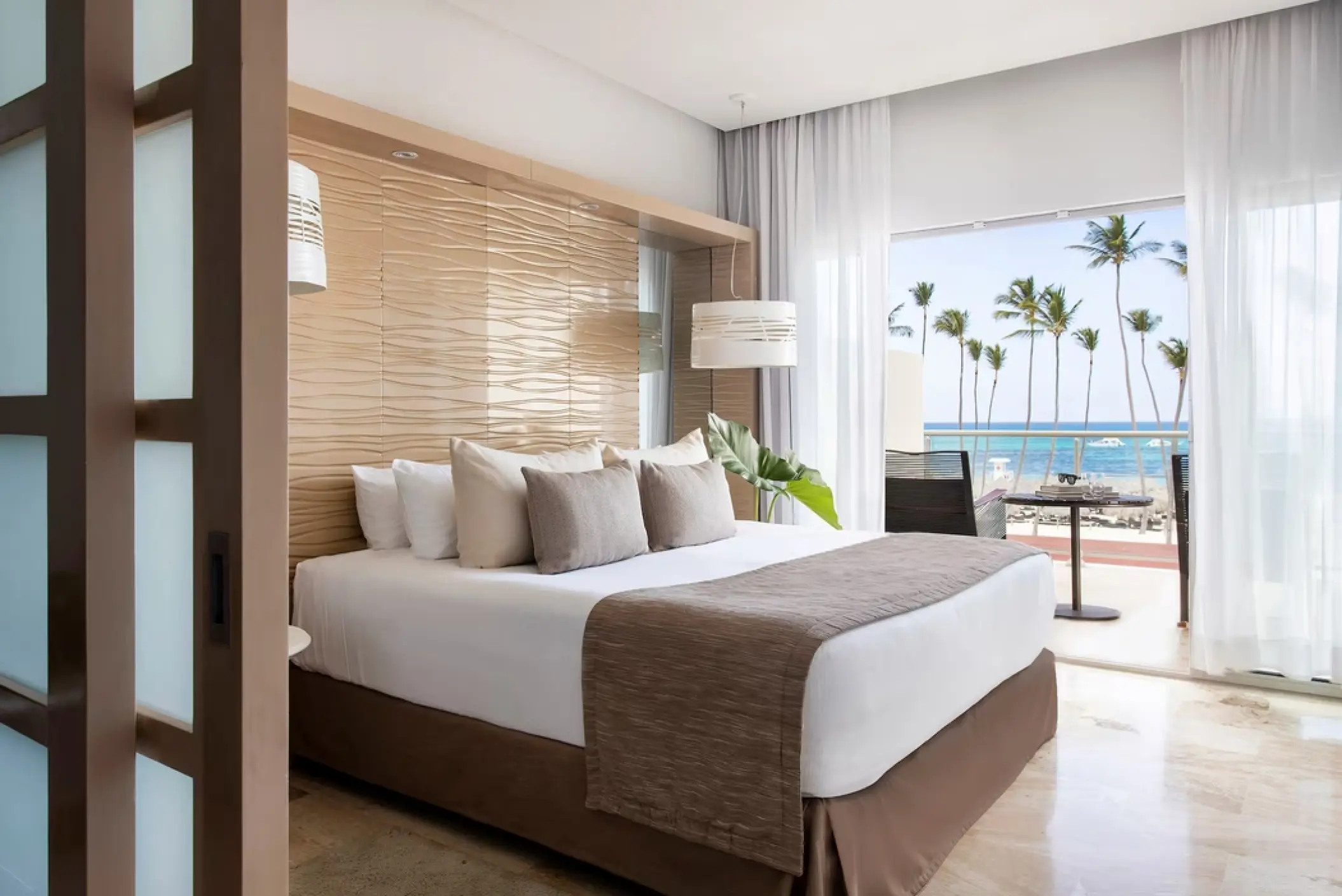Junior suite with ocean views and palm trees at Paradisus Palma Real, Punta Cana