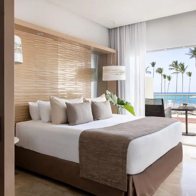 Junior suite with ocean views and palm trees at Paradisus Palma Real, Punta Cana