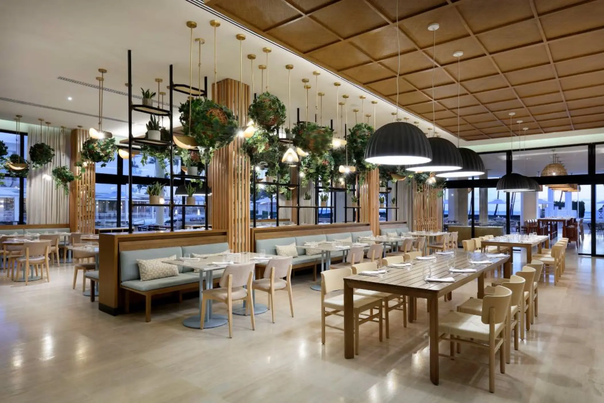 Malva Food Bazaar restaurant interior with hanging plants and dome lighting at Paradisus Palma Real, Punta Cana