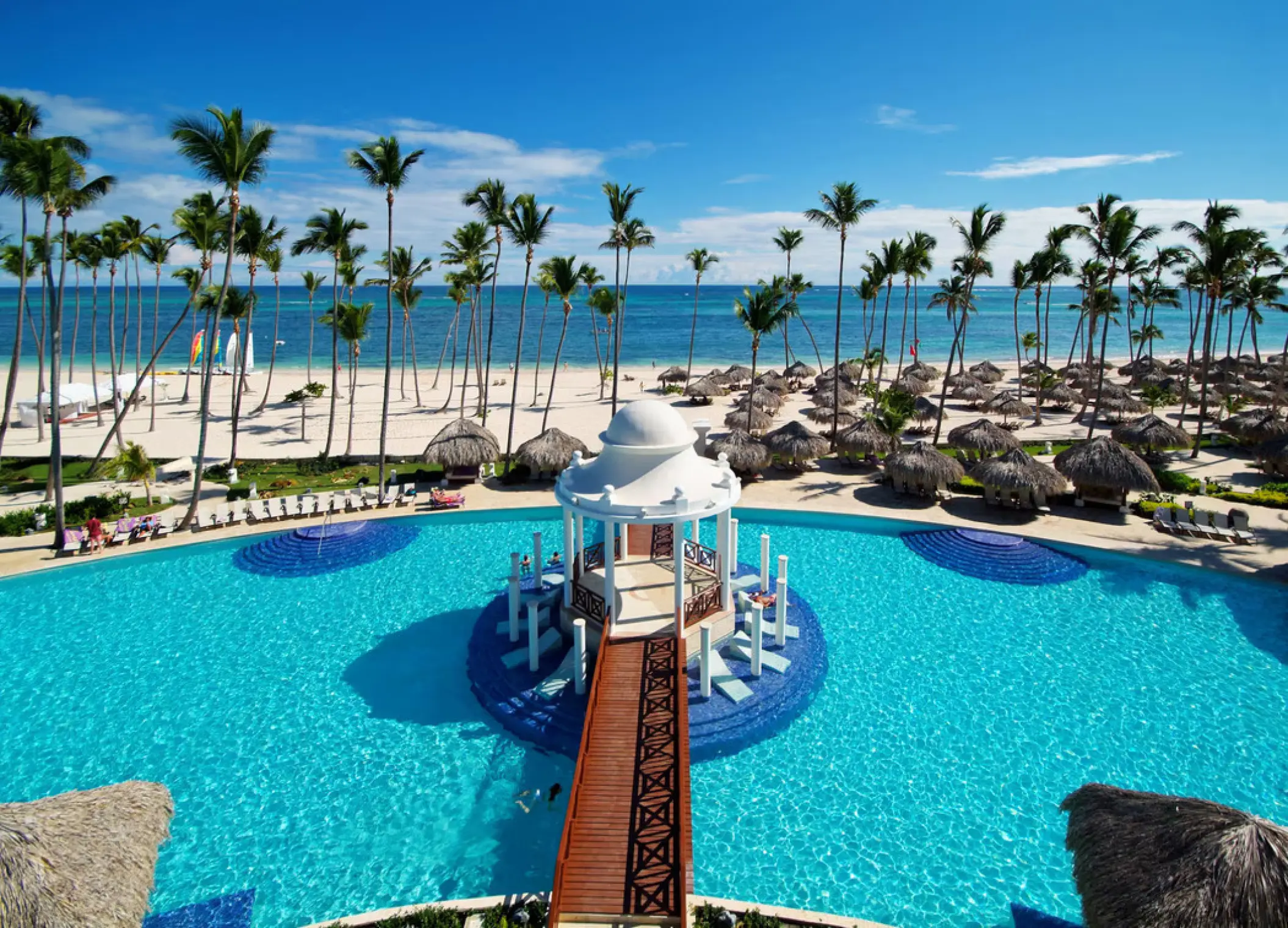 Poolside gazebo and white sand beach at Paradisus Palma Real, Punta Cana