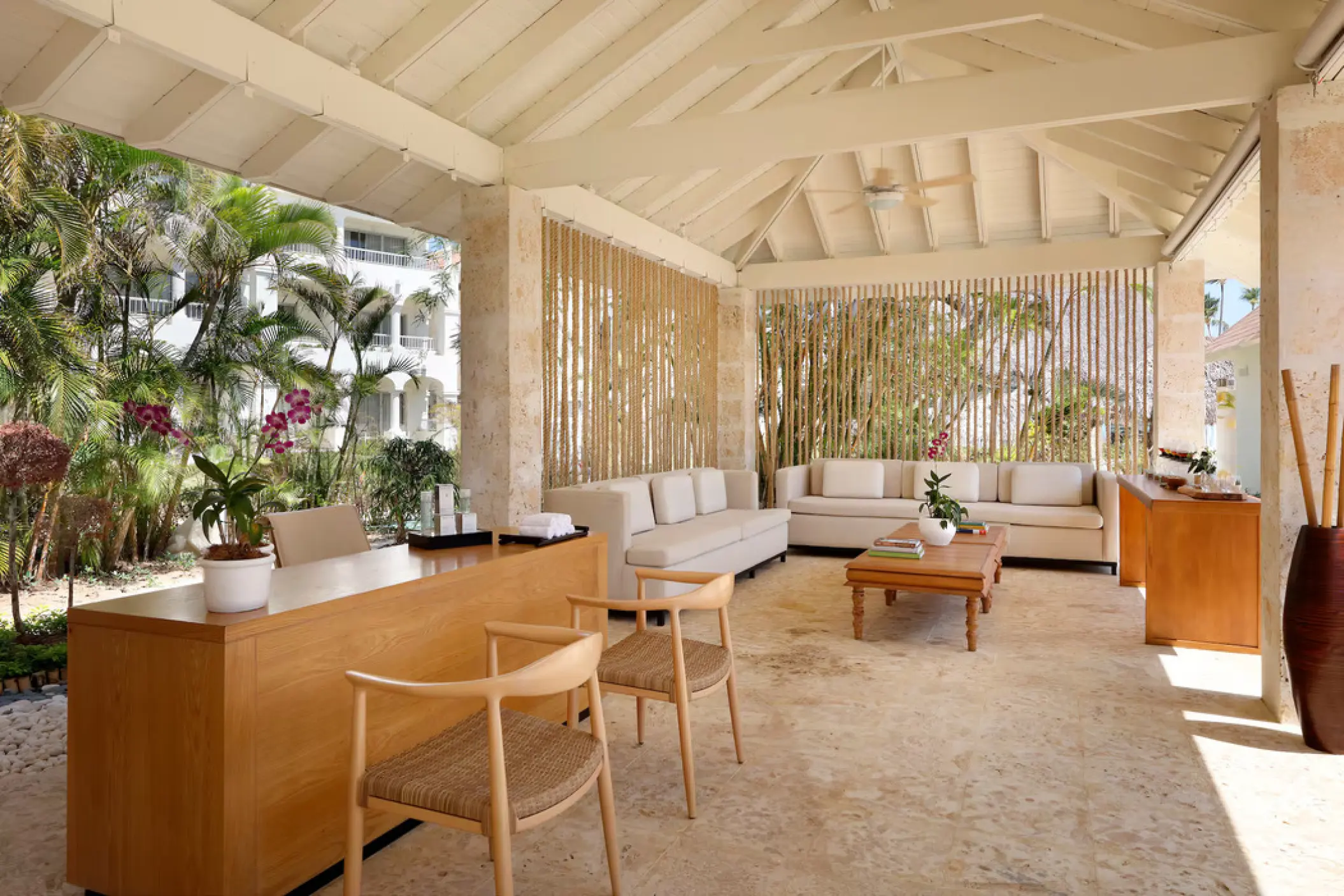 Spa lobby area with wood furnishings and bamboo screens at Paradisus Palma Real, Punta Cana
