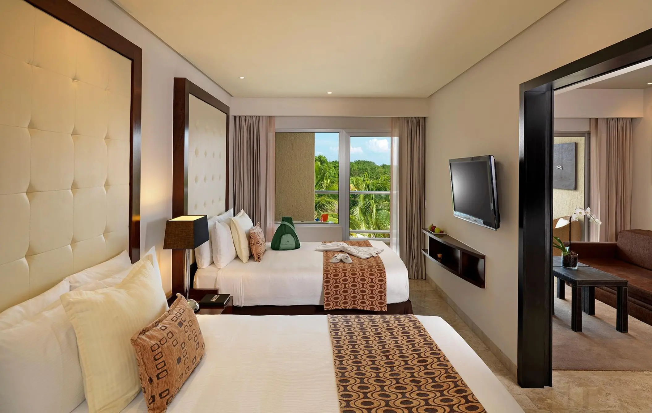 Garden view suite with two beds and a living area at Paradisus Playa Del Carmen
