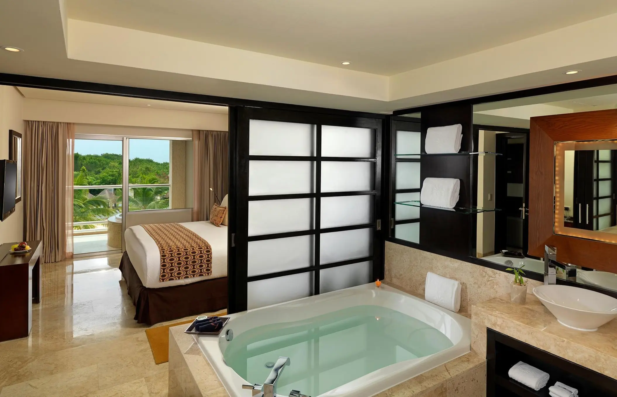Paradisus Playa Del Carmen garden view suite featuring a private soaking tub and balcony