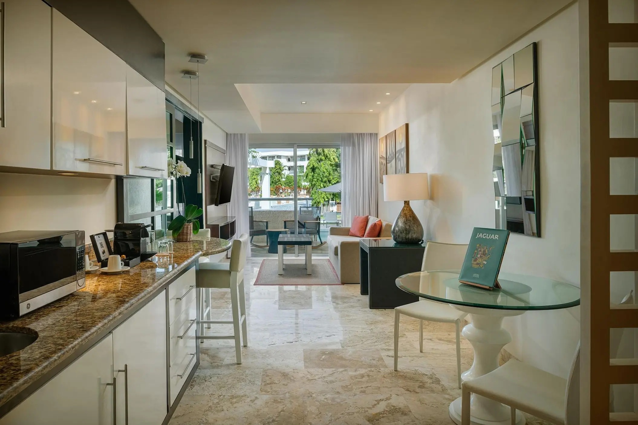 Modern swim-up suite interior with living area and kitchenette at Paradisus Playa Del Carmen
