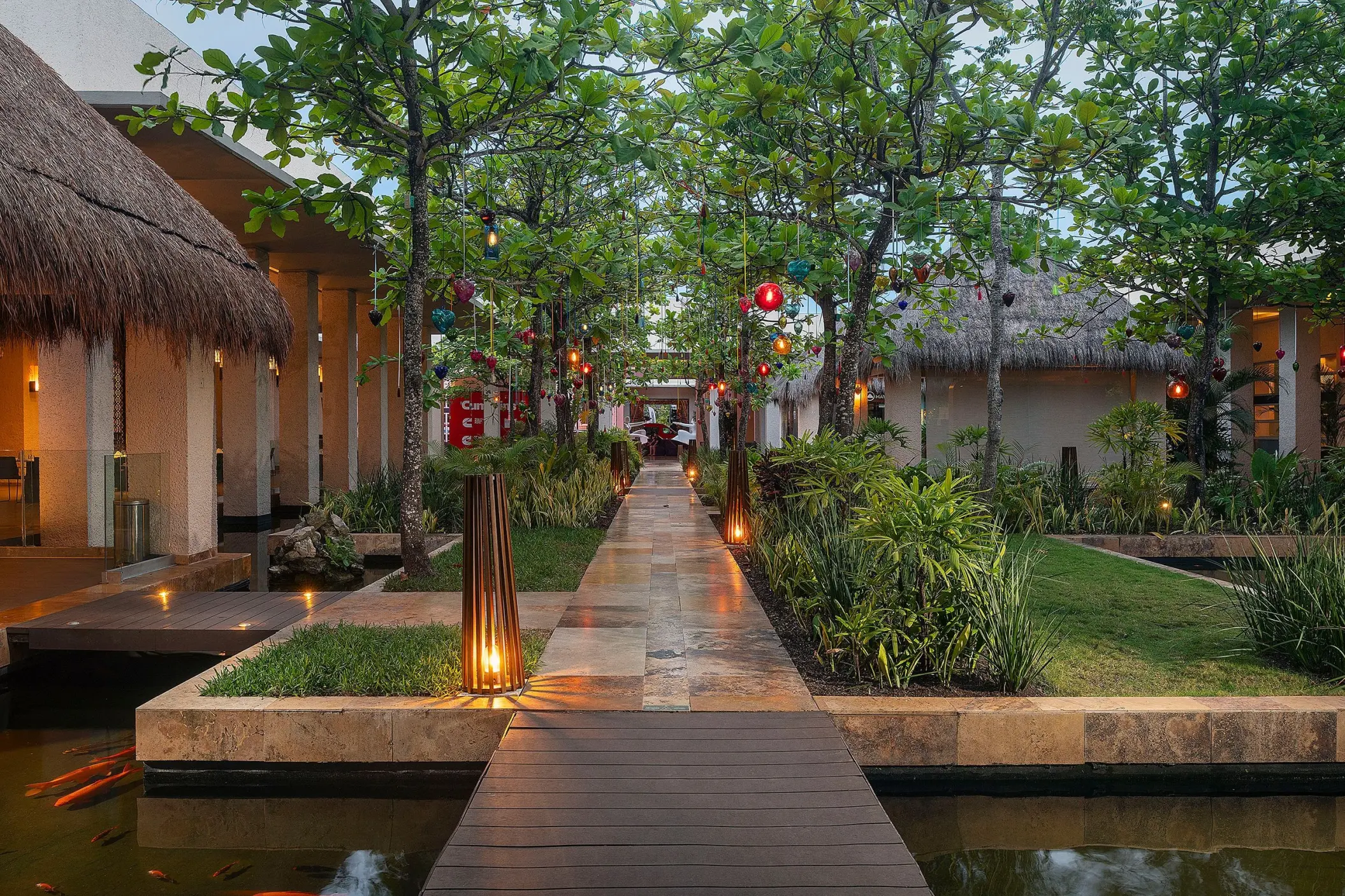Paradisus Playa Del Carmen lush garden walkway with hanging lanterns and water features, Playa Del Carmen