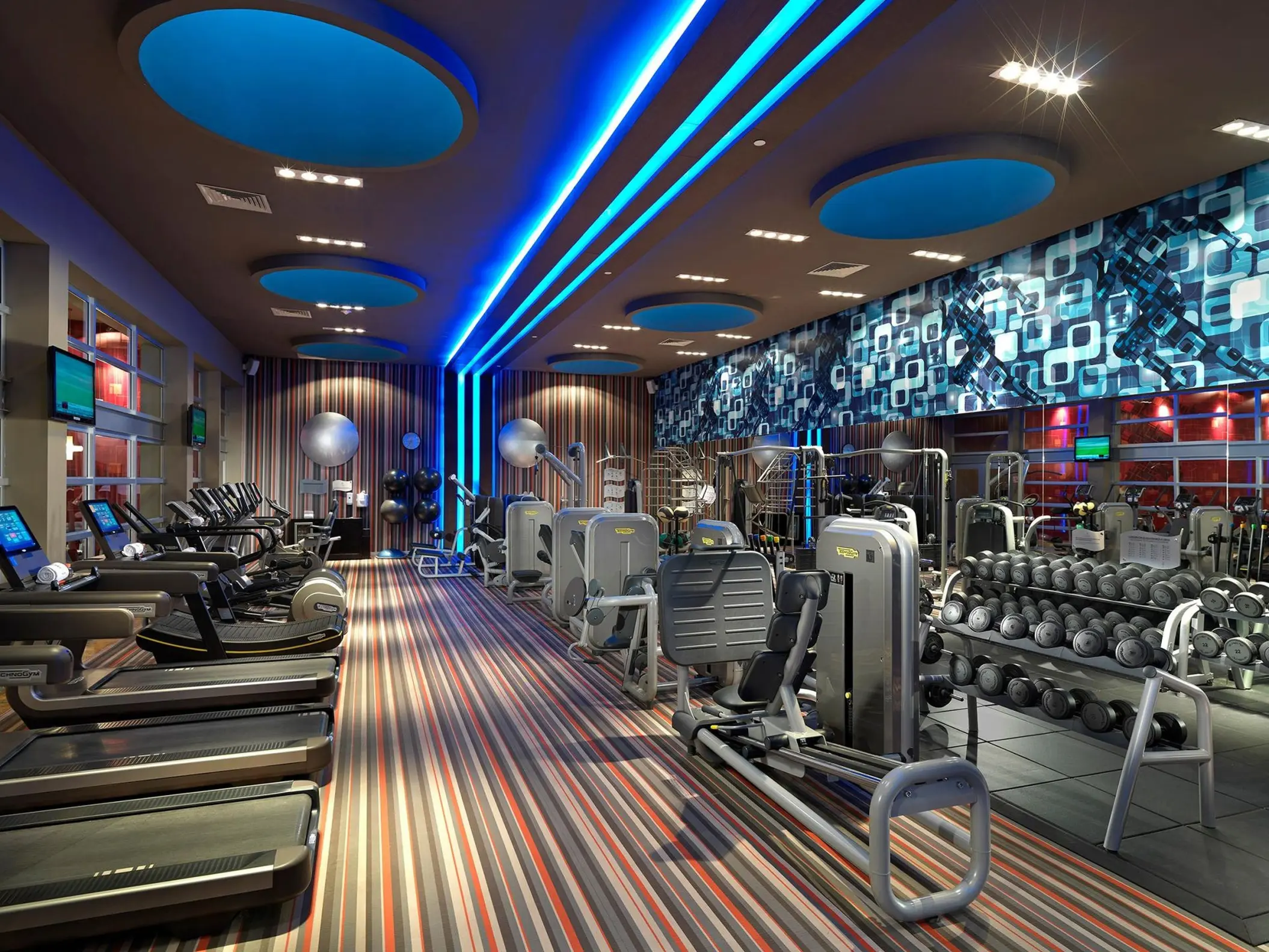 Modern fitness center with treadmills and weight equipment at Paradisus Playa Del Carmen