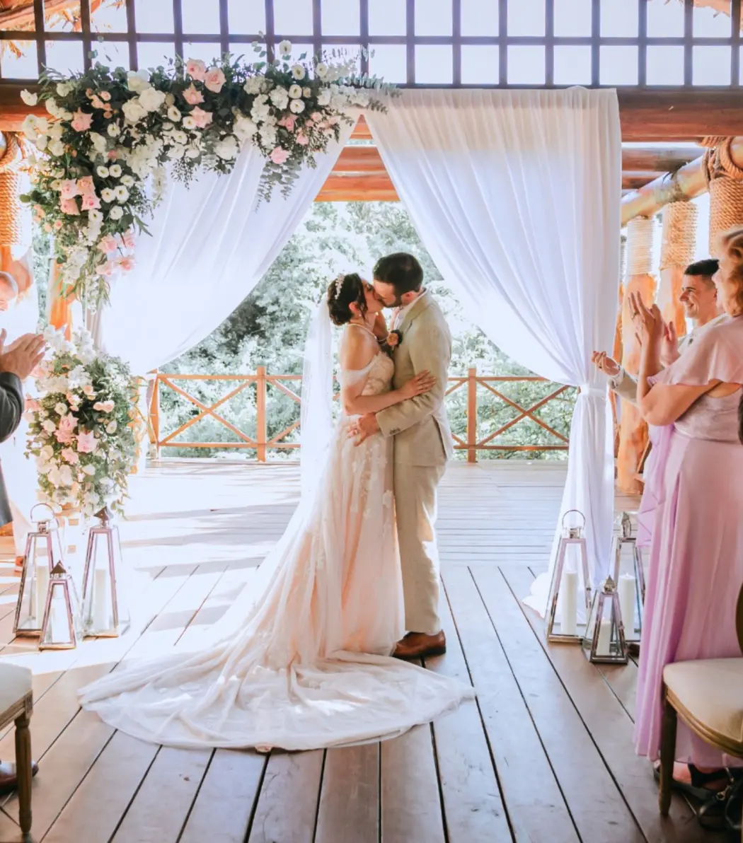 The couple kissing during a gazebo wedding ceremony at Paradisus La Perla, Playa Del Carmen