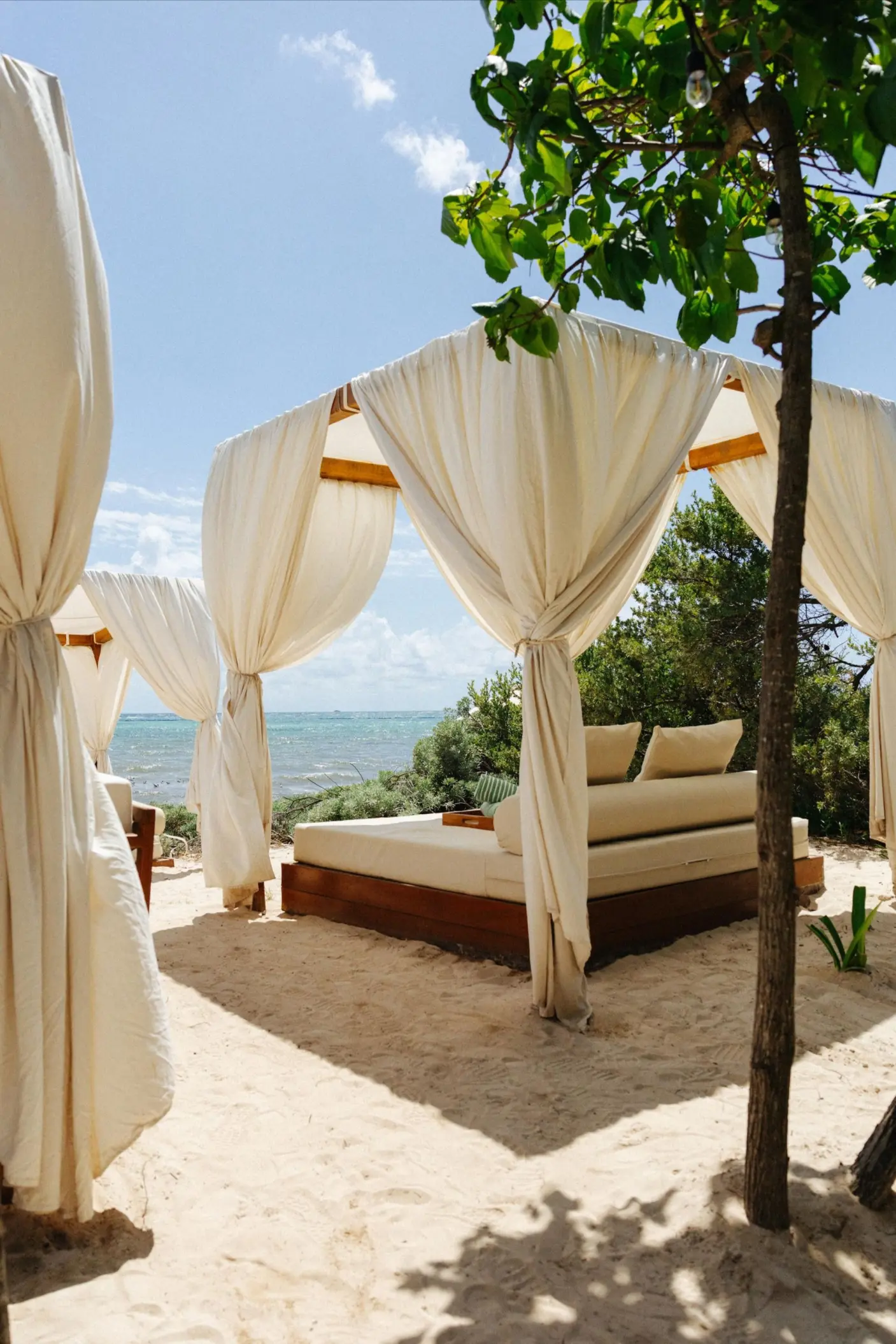 Private beach cabana with cream curtains at Paradisus Playa Del Carmen