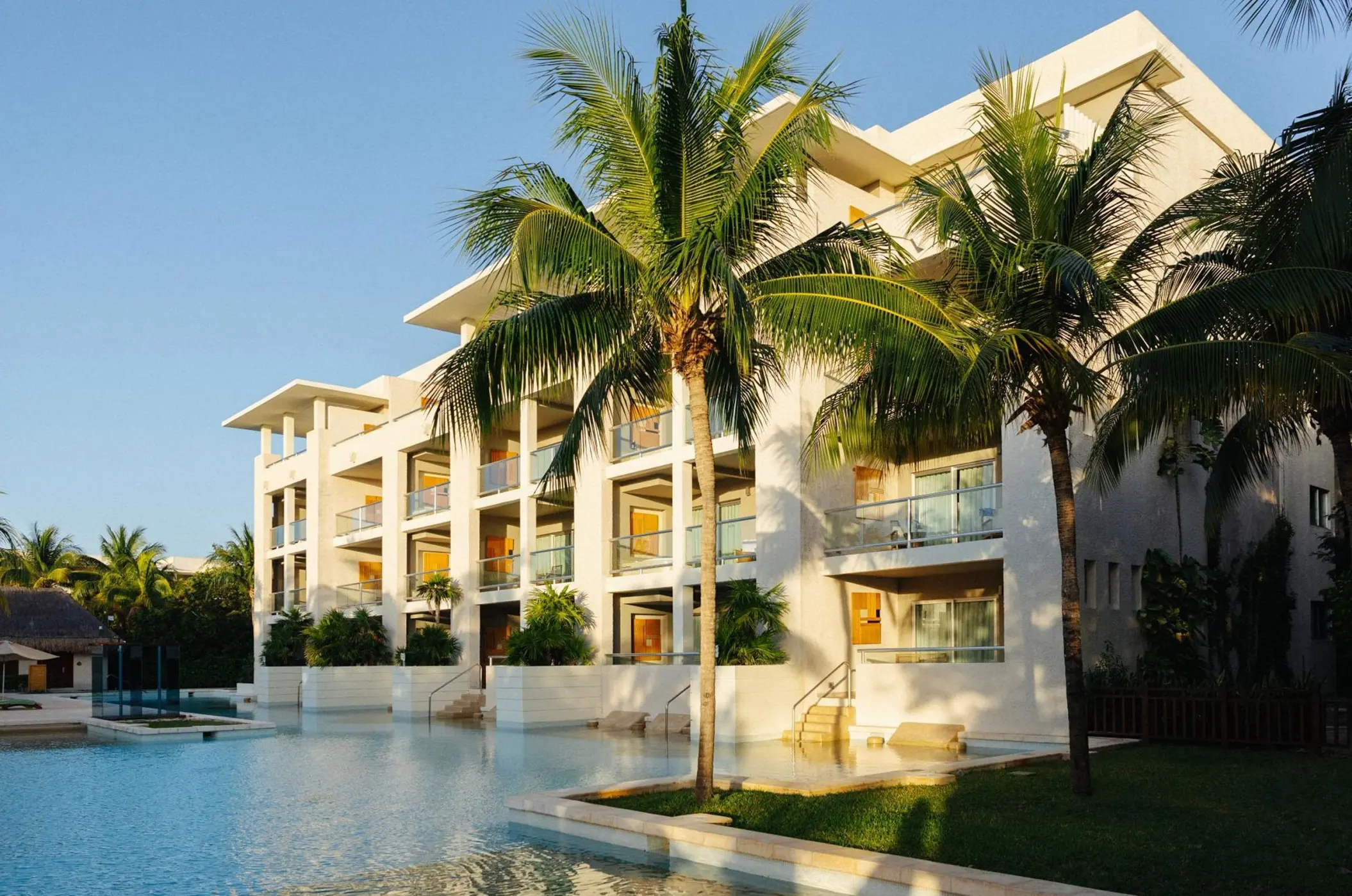 Swim-up suites and palm trees at Paradisus Playa Del Carmen