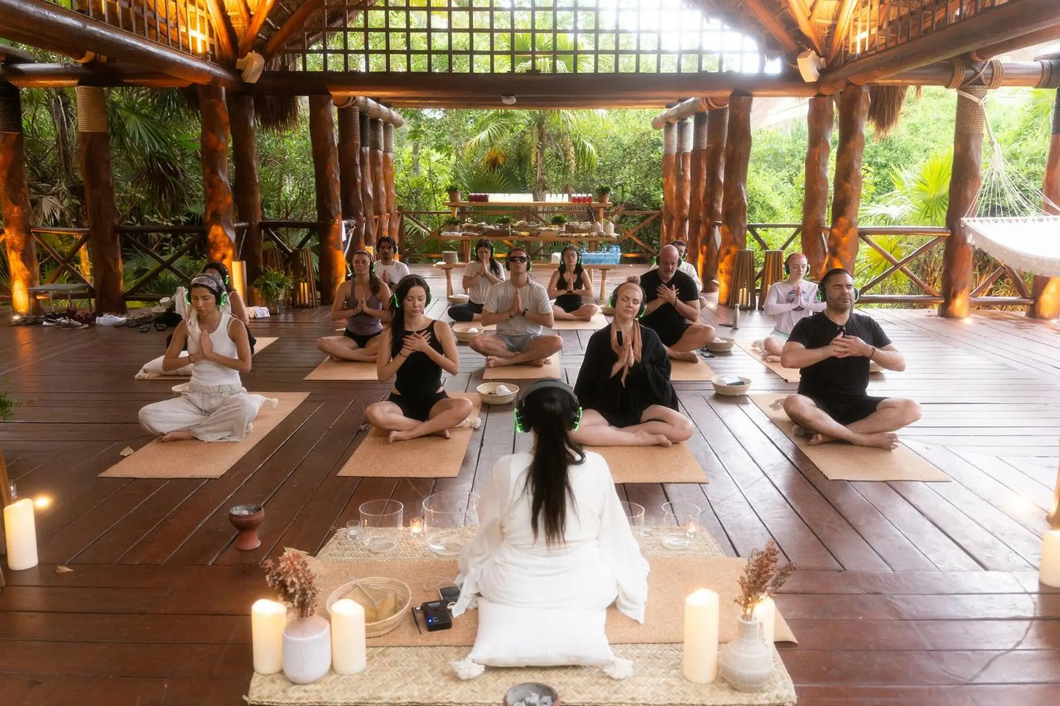 Group yoga and meditation session in a wooden pavilion at Paradisus Playa Del Carmen