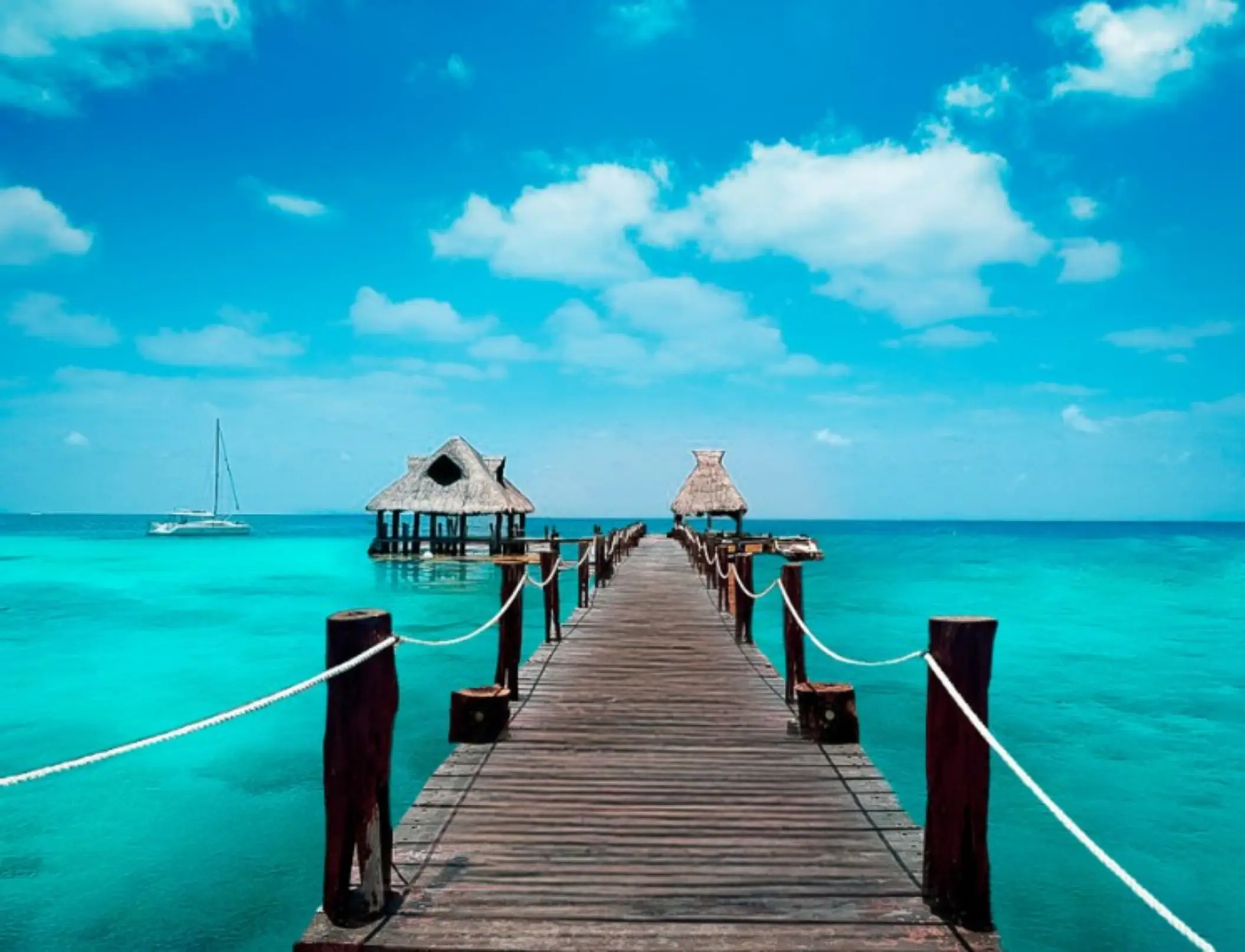Wooden ocean pier venue at Royalton Reserve Paraiso de la Bonita over turquoise water, Riviera Maya