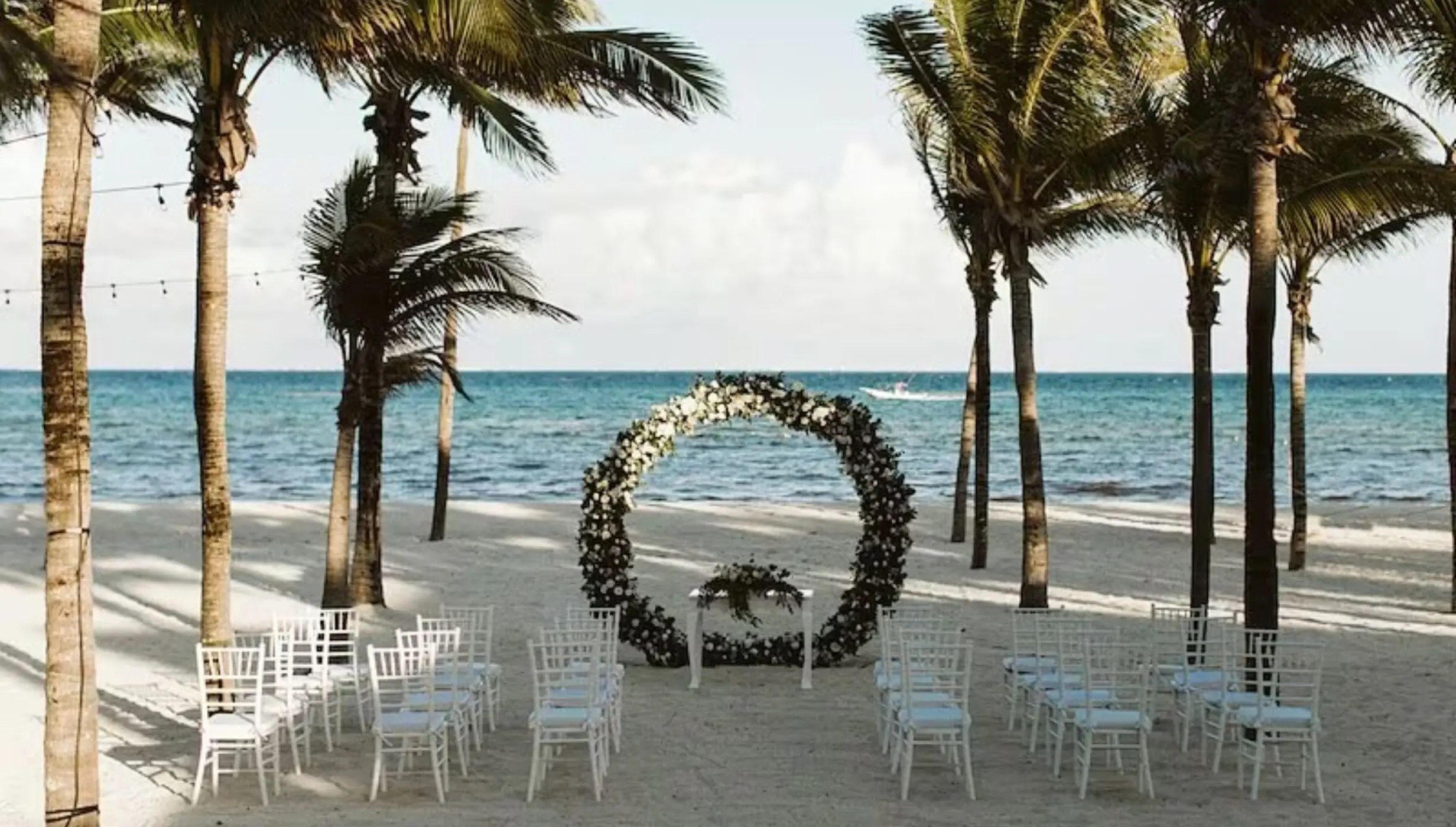 Beachfront wedding ceremony with a circular floral arch at Riu Montego Bay