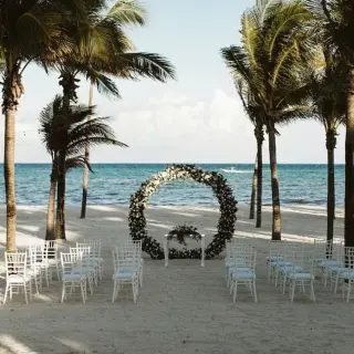 Beachfront wedding ceremony with a circular floral arch at Riu Montego Bay