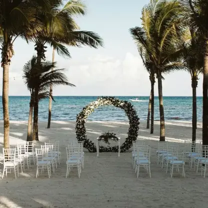 Beachfront wedding ceremony with a circular floral arch at Riu Montego Bay