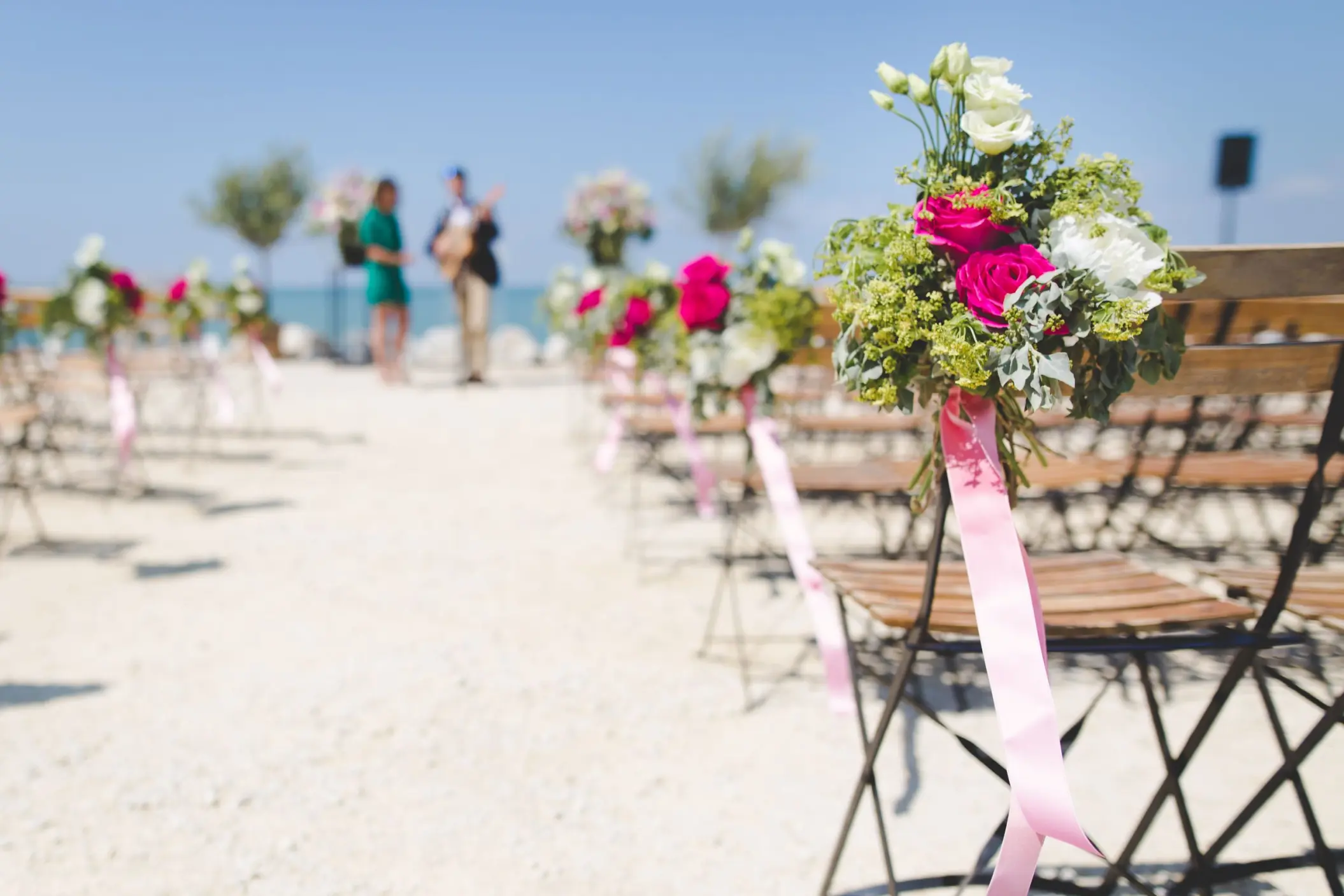 Beachfront wedding ceremony chairs with pink floral decor at Riu Montego Bay, Montego Bay