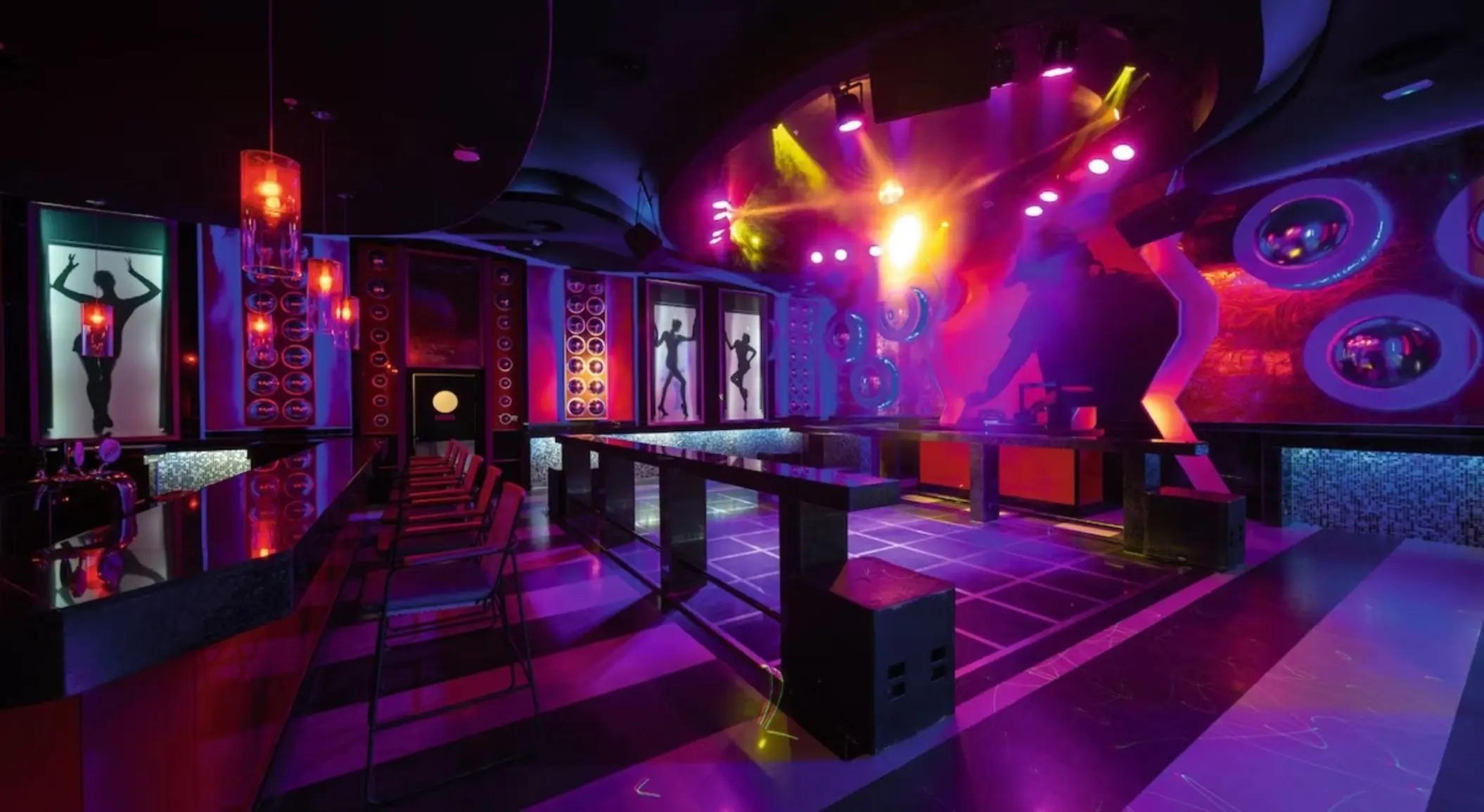 Pacha nightclub dance floor with neon lights and bar at Riu Montego Bay