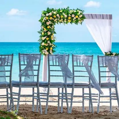 Beachfront wedding ceremony setup with floral arch at Riu Palace Tropical Bay, Negril