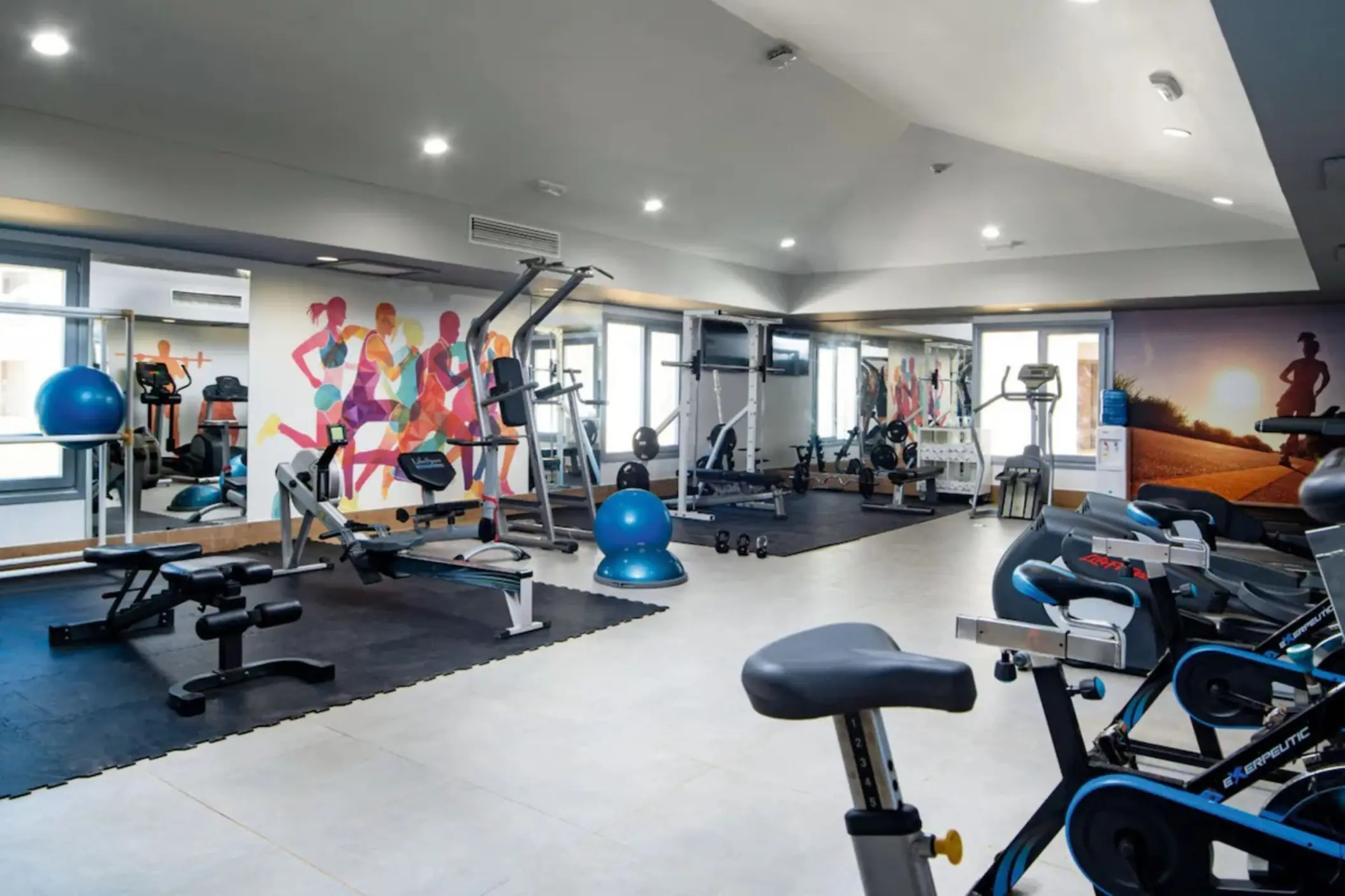 Indoor gym with weight machines and exercise bikes at Riu Palace Tropical Bay, Negril