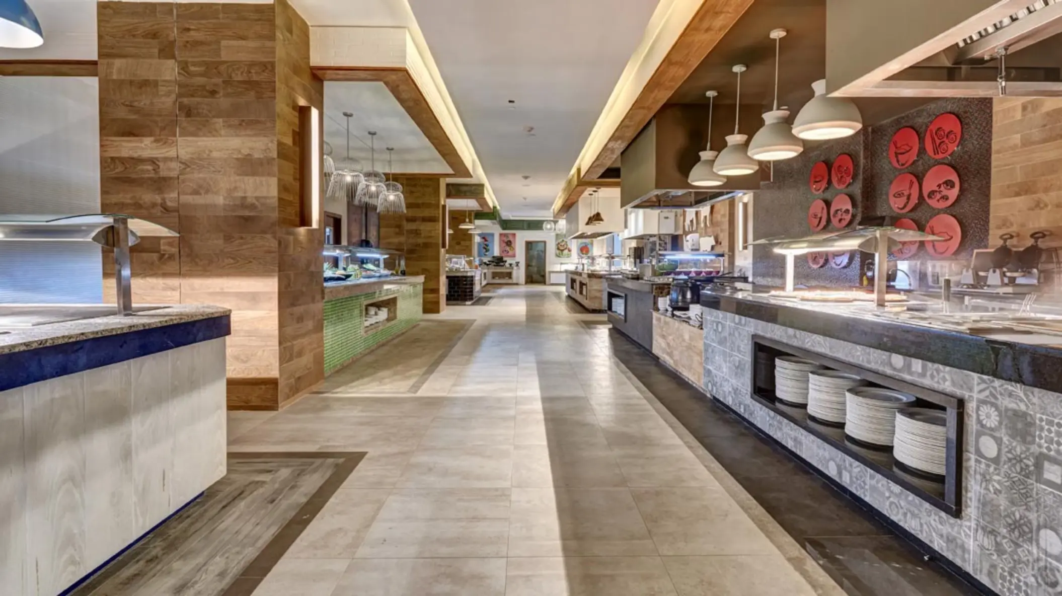 Buffet restaurant food stations with modern lighting and wood accents at Royalton Antigua, Five Islands Village