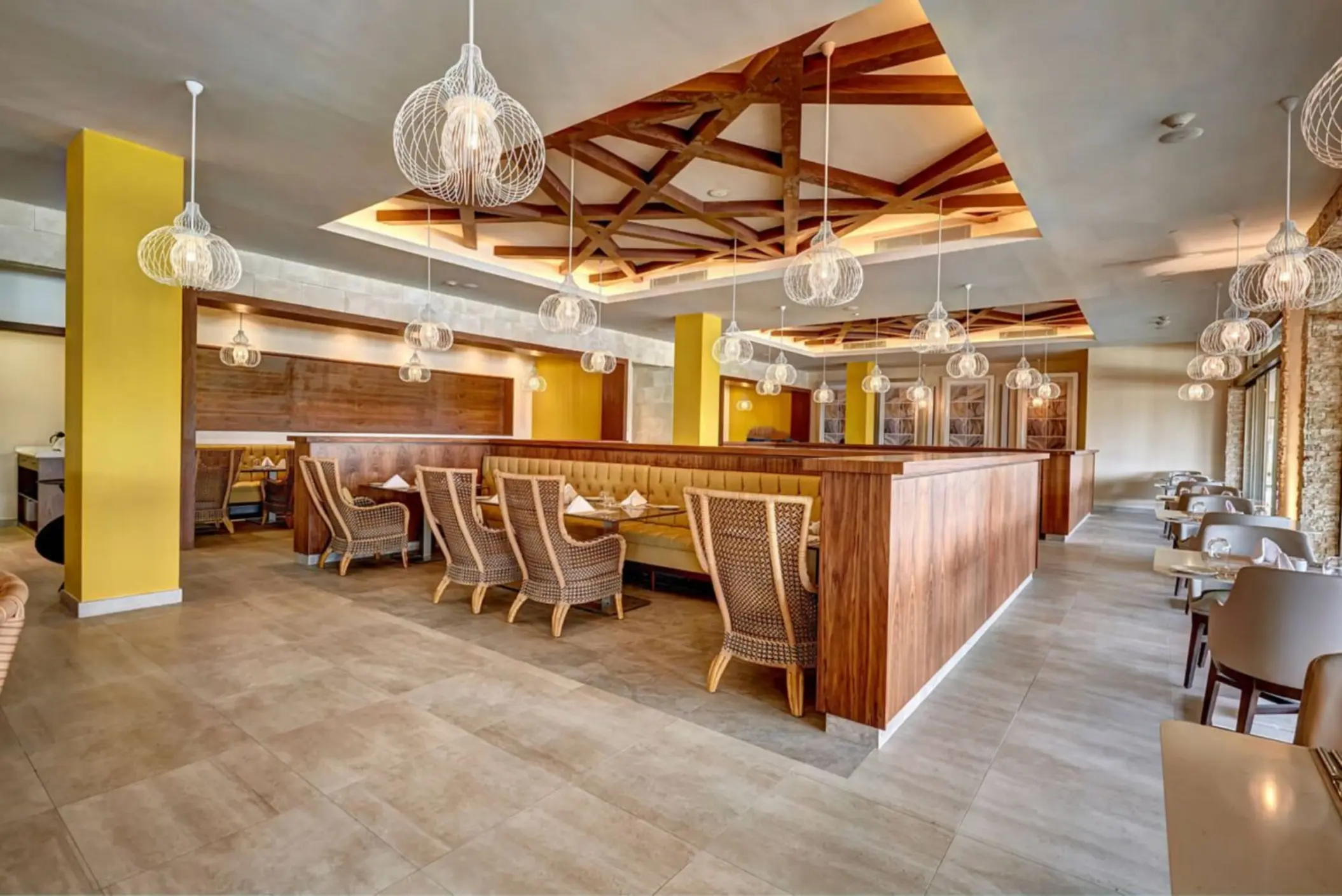 Gourmet Marche restaurant with cage pendant lights and wooden ceiling details at Royalton Antigua, Five Islands Village