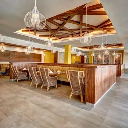 Gourmet Marche restaurant with cage pendant lights and wooden ceiling details at Royalton Antigua, Five Islands Village