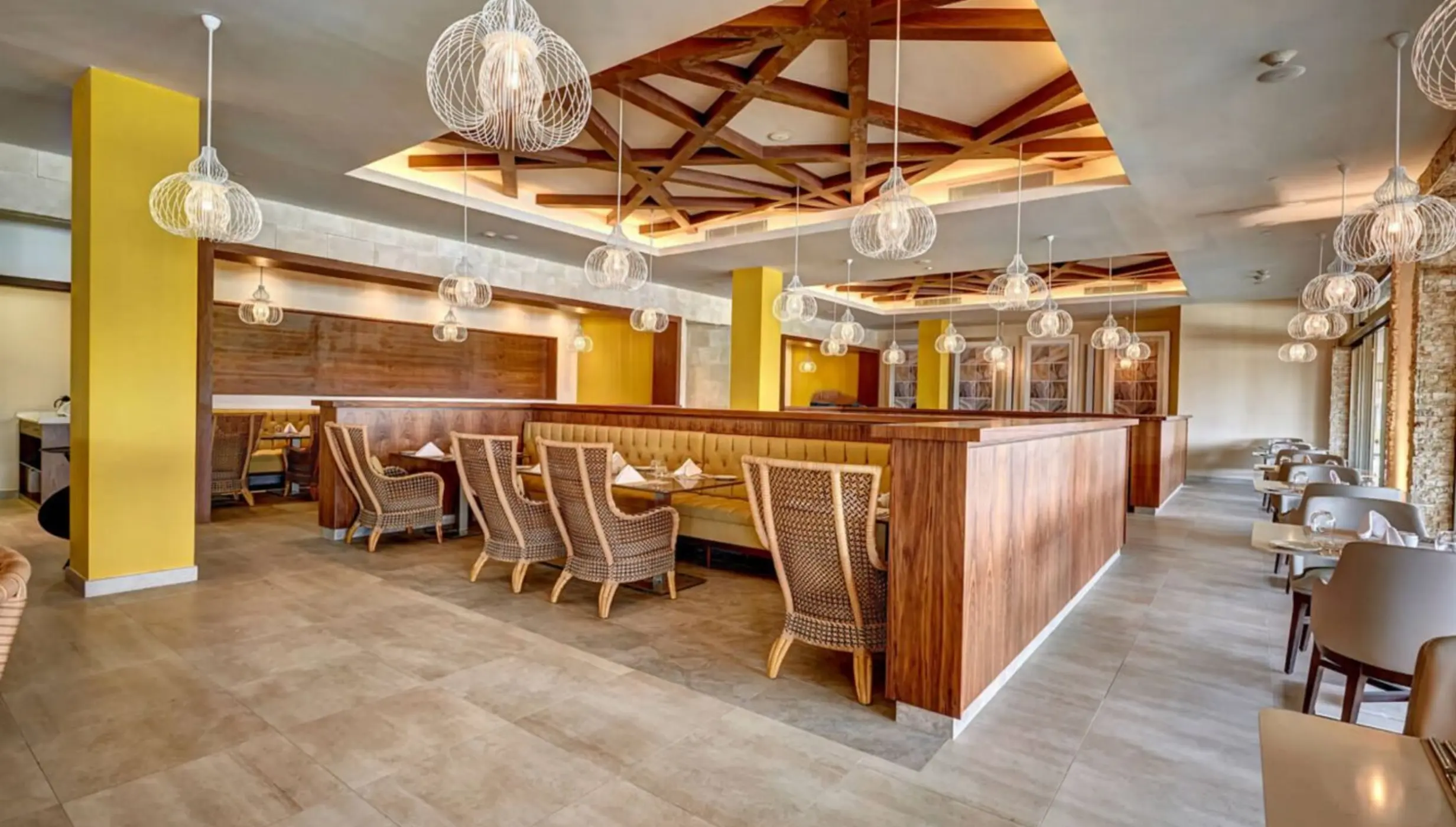 Gourmet Marche restaurant with cage pendant lights and wooden ceiling details at Royalton Antigua, Five Islands Village