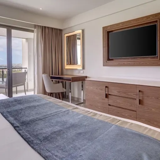 Royalton Antigua oceanfront suite with balcony and modern wood furnishings, Five Islands Village