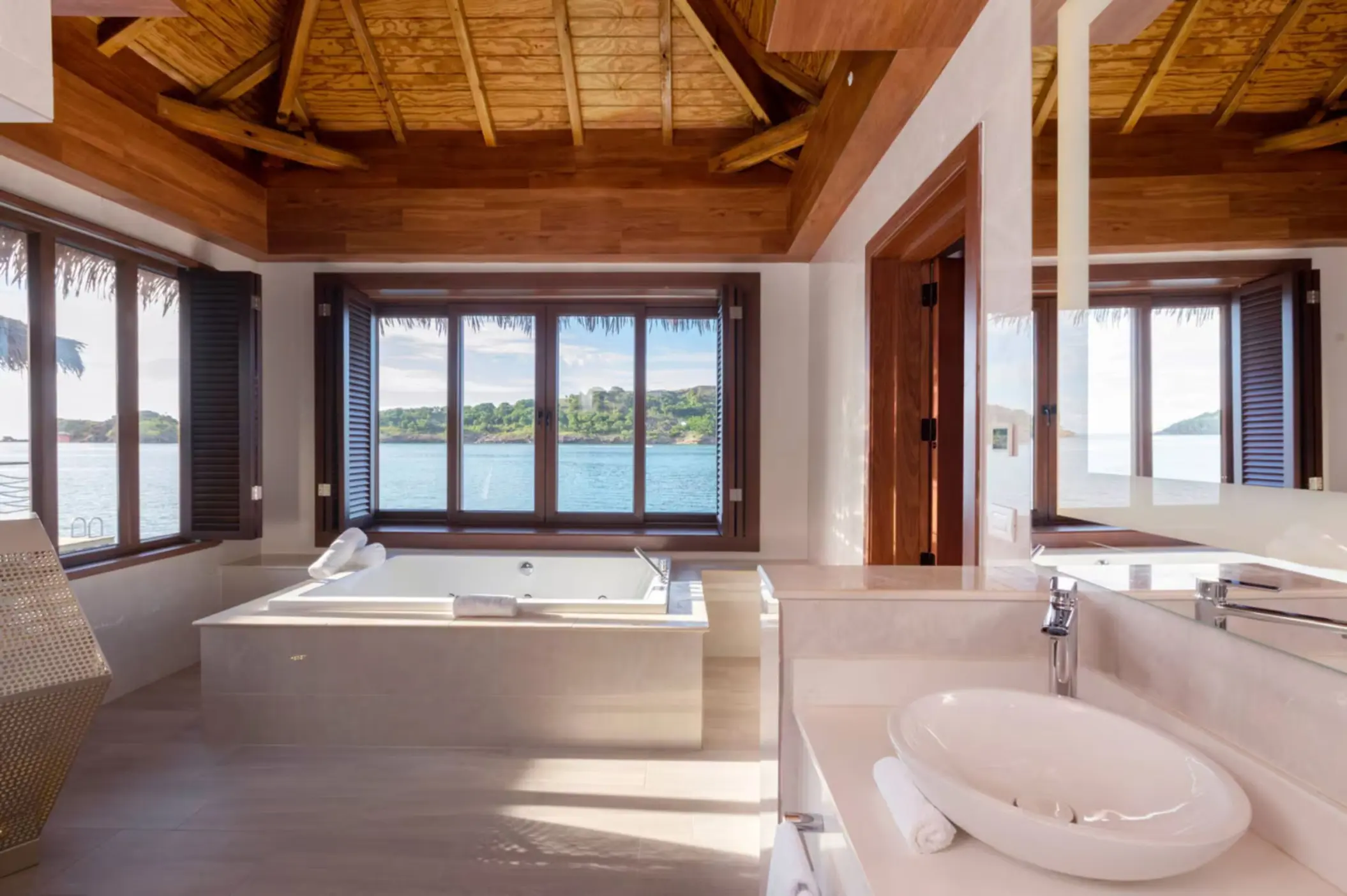 Chairman Overwater Bungalow bathroom with a jetted soaking tub at Royalton Antigua, Five Islands Village