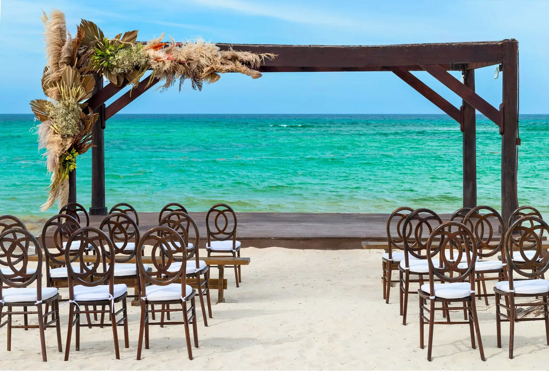 Beachfront wedding ceremony with a dark wood gazebo at Royalton Bavaro, Punta Cana