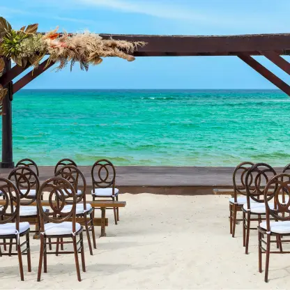 Beachfront wedding ceremony with a dark wood gazebo at Royalton Bavaro, Punta Cana
